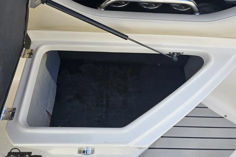 Slide: The Image of Open storage compartment on a 2008 Regal 2520 FasDeck boat. - 55