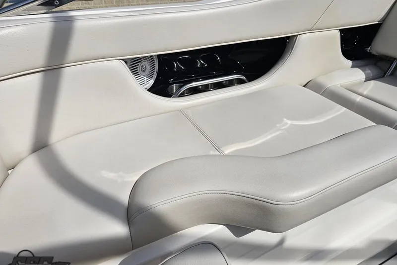 Slide: The Image of Interior seating of a 2008 Regal 2520 FasDeck boat, featuring sleek white upholstery. - 57