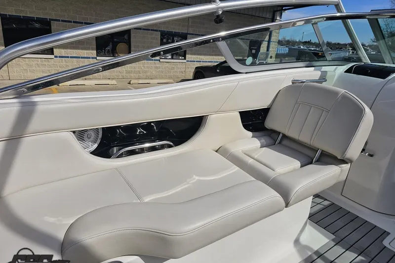 Slide: The Image of Interior of a 2008 Regal 2520 FasDeck boat with beige seating and sleek design. - 58