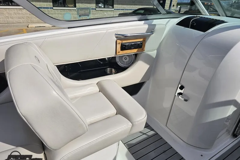 Slide: The Image of Interior of a 2008 Regal 2520 FasDeck boat with white seating and dashboard. - 63