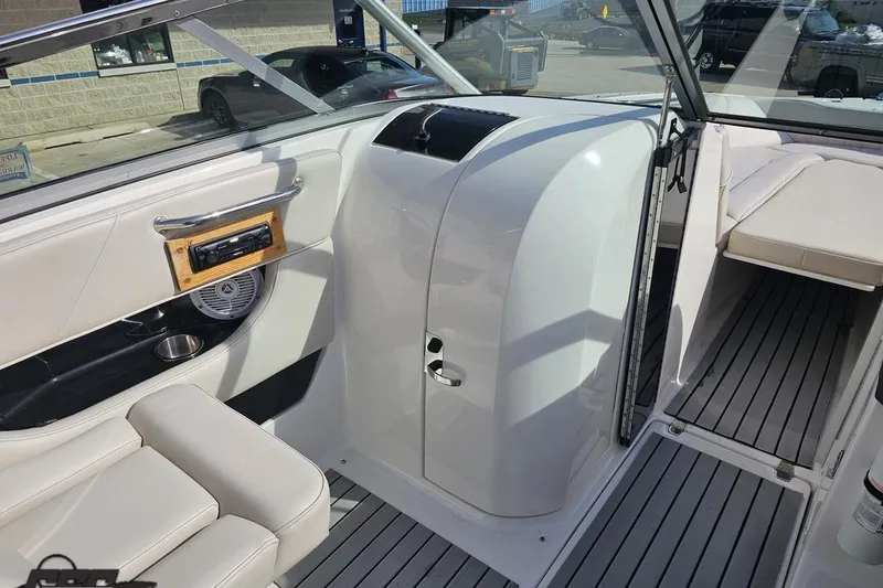 Slide: The Image of Interior view of a 2008 Regal 2520 FasDeck boat with white seating and sleek design. - 64