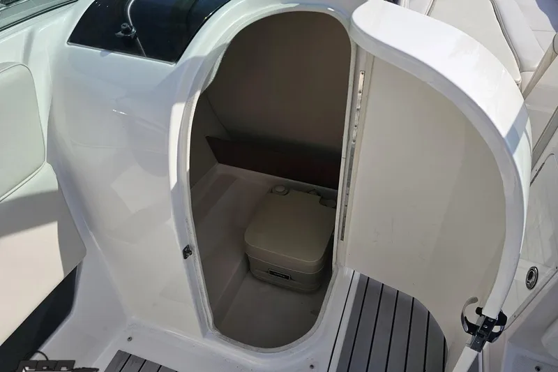 Slide: The Image of 2008 Regal 2520 FasDeck boat interior with open compartment and portable toilet. - 67