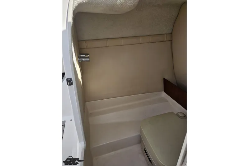Slide: The Image of Interior cabin of 2008 Regal 2520 FasDeck boat, featuring beige upholstery and compact design. - 69