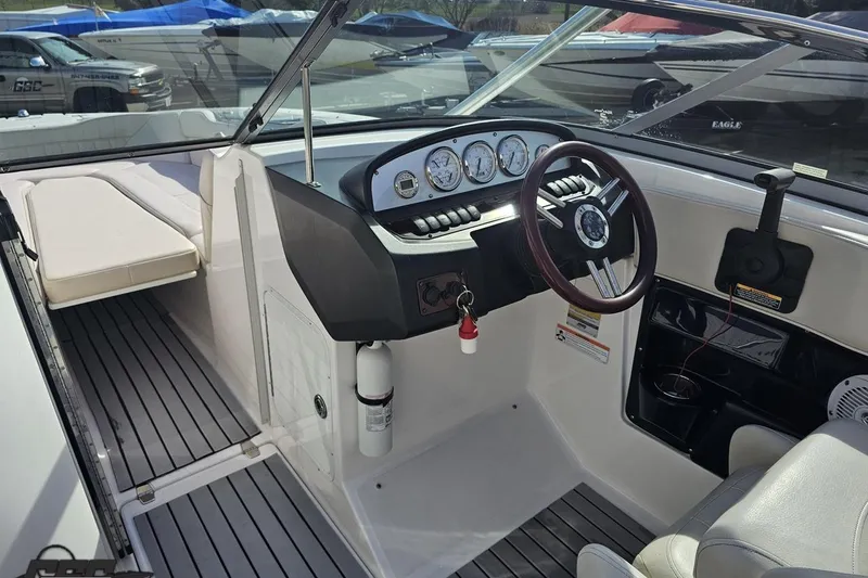 Slide: The Image of 2008 Regal 2520 FasDeck boat interior with steering wheel and dashboard controls. - 70