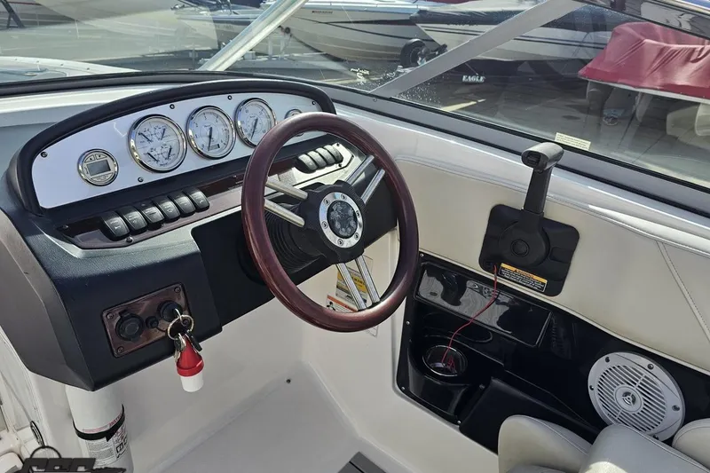 Slide: The Image of Cockpit of 2008 Regal 2520 FasDeck boat with steering wheel and instrument panel. - 71