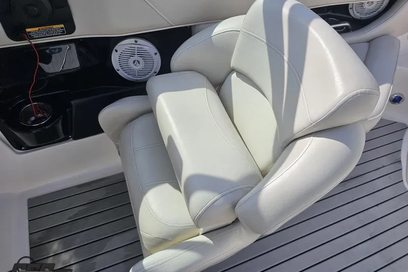 Slide: The Image of White leather seat on 2008 Regal 2520 FasDeck boat, featuring speaker and cup holder. - 74