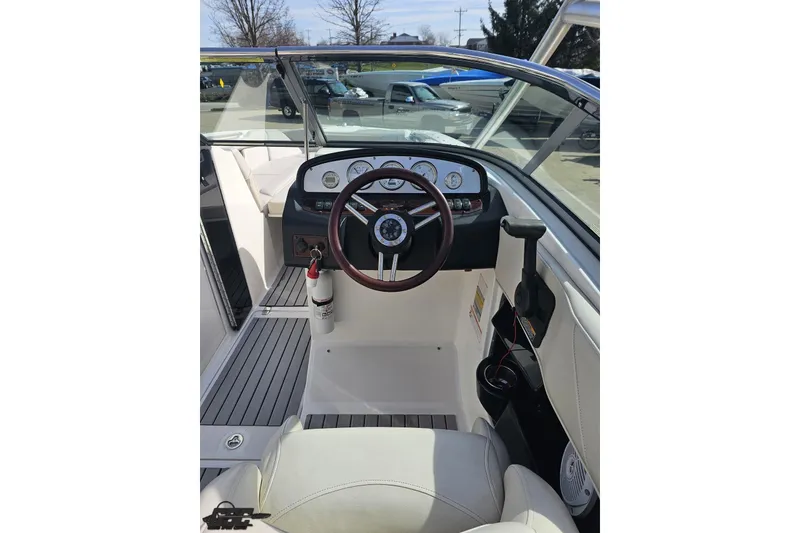 Slide: The Image of 2008 Regal 2520 FasDeck boat cockpit with steering wheel and dashboard controls. - 75