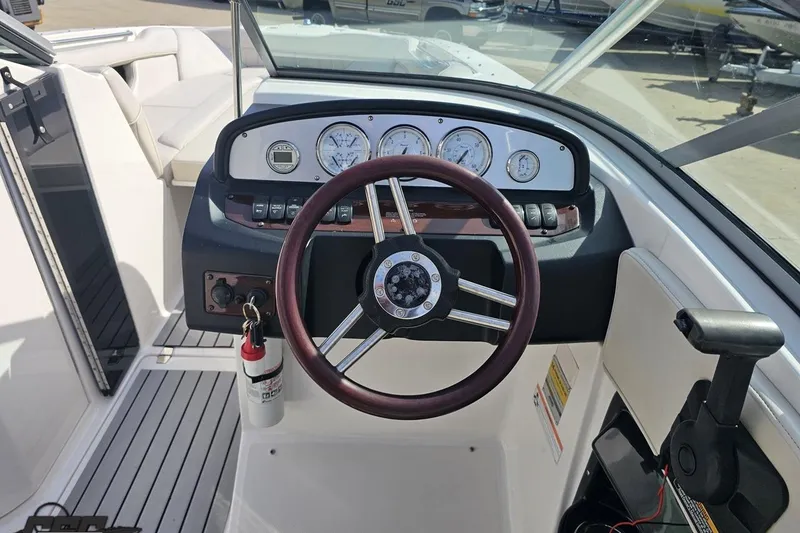 Slide: The Image of 2008 Regal 2520 FasDeck boat dashboard with steering wheel and gauges. - 76