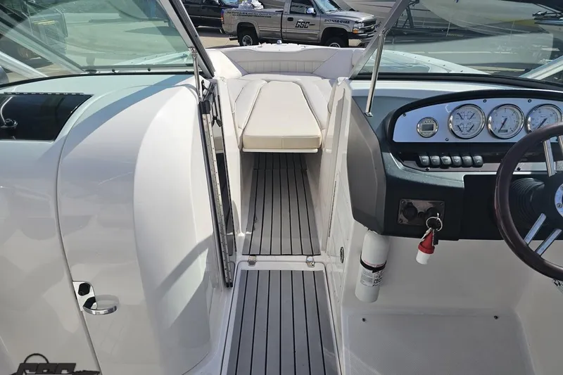 Slide: The Image of 2008 Regal 2520 FasDeck boat interior with steering wheel, gauges, and seating area. - 79