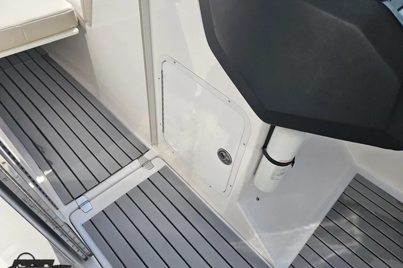 Slide: The Image of 2008 Regal 2520 FasDeck boat interior with gray striped flooring and storage compartment. - 82