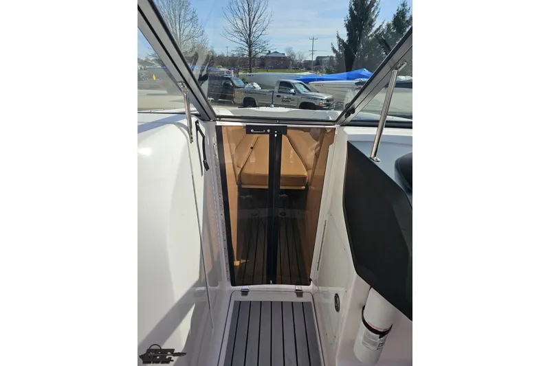 Slide: The Image of 2008 Regal 2520 FasDeck boat interior with open cabin door and visible seating area. - 84
