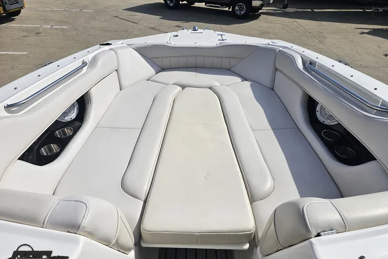 Slide: The Image of 2008 Regal 2520 FasDeck boat interior with white cushioned seating and cup holders. - 86