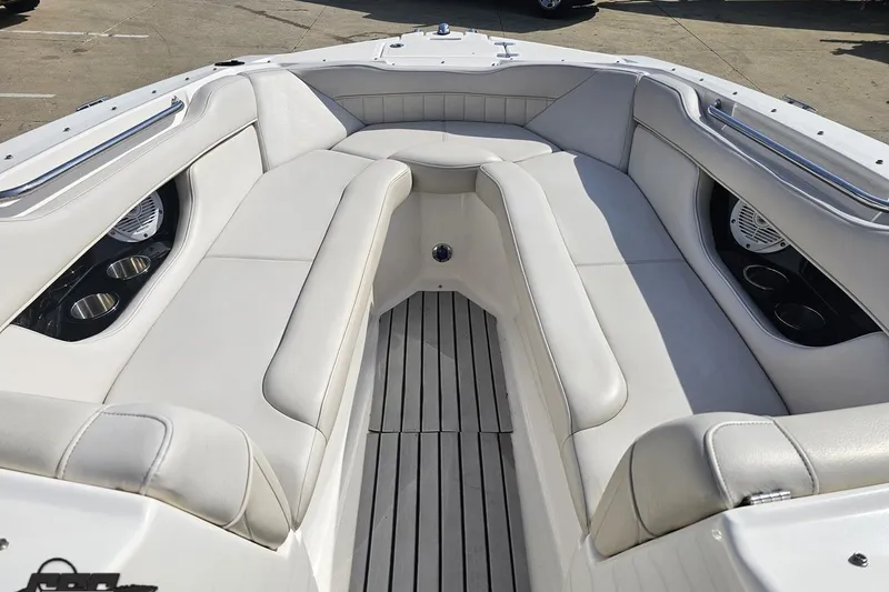 Slide: The Image of 2008 Regal 2520 FasDeck boat interior with white seating and cup holders. - 88