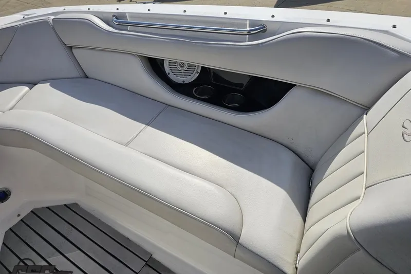 Slide: The Image of 2008 Regal 2520 FasDeck boat interior with white leather seating and speaker system. - 90