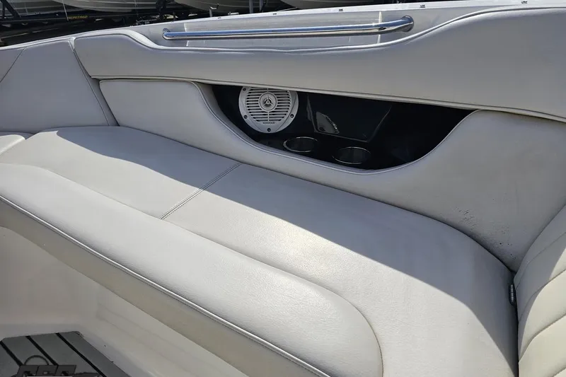 Slide: The Image of 2008 Regal 2520 FasDeck boat interior with white seating and built-in speaker. - 91