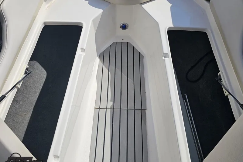 Slide: The Image of Interior view of a 2008 Regal 2520 FasDeck boat, showcasing storage compartments and flooring. - 95