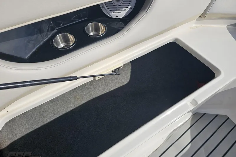 Slide: The Image of Interior of 2008 Regal 2520 FasDeck boat showing storage compartment and cup holders. - 96