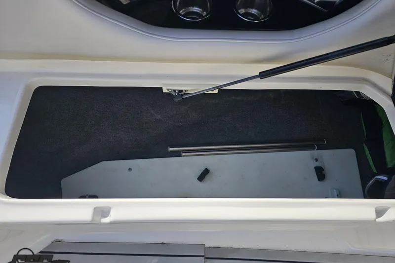 Slide: The Image of Open storage compartment in a 2008 Regal 2520 FasDeck boat, showing interior details. - 97