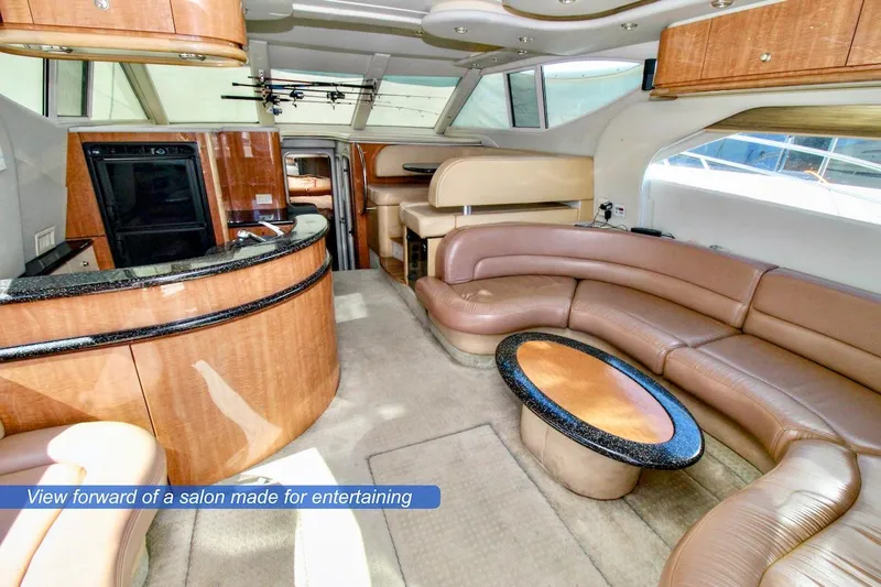 Slide: The Image of Luxurious interior of 2002 Maxum 4600 SCB yacht with elegant seating and entertainment area. - 10