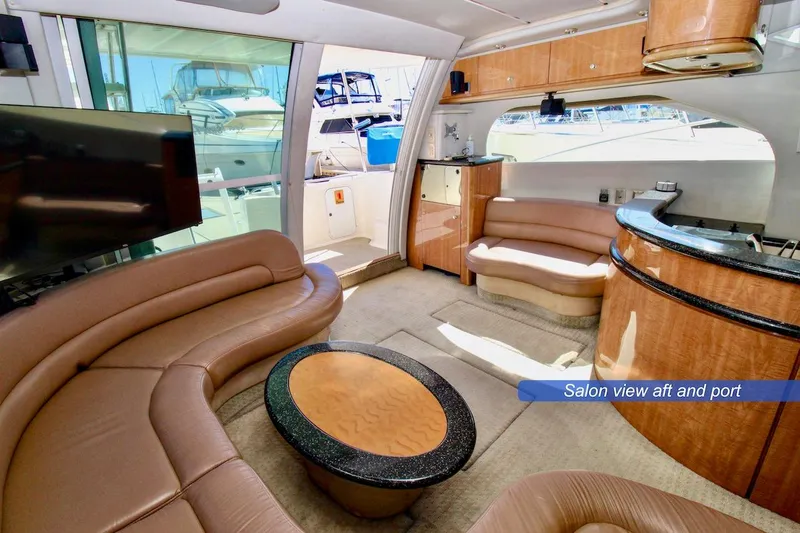 Slide: The Image of Luxurious salon interior of 2002 Maxum 4600 SCB yacht, featuring elegant seating and modern amenities. - 11