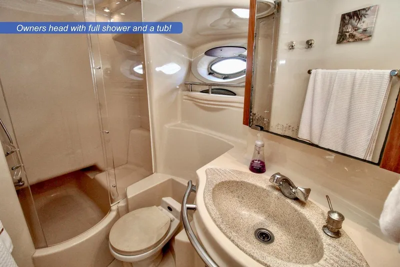 Slide: The Image of Luxurious 2002 Maxum 4600 SCB yacht bathroom with shower, tub, and elegant fixtures. - 16