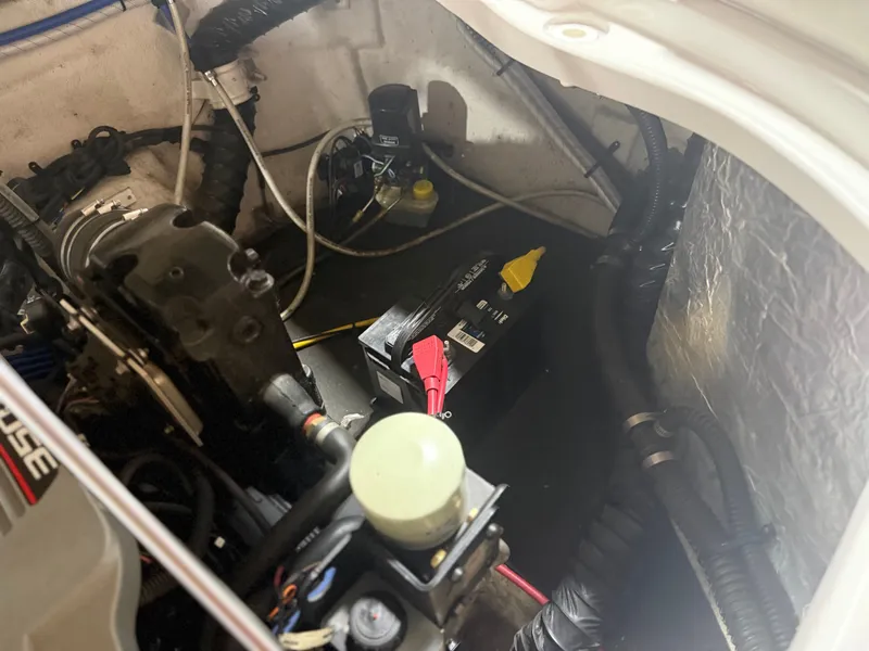 Slide: The Image of Engine compartment of a 2009 Crownline 240 LS with battery and cables. - 11