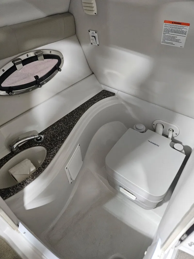 Slide: The Image of Interior of a 2009 Crownline 240 LS with toilet and sink. - 2