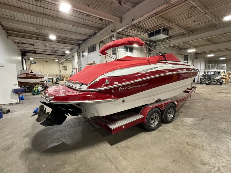 Slide: The Image of 2009 Crownline 240 LS boat in warehouse, red and white design. - 5