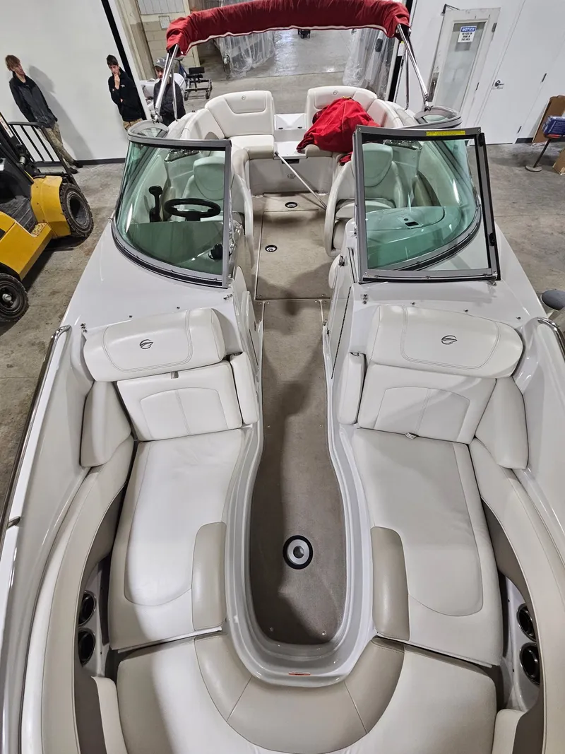 Slide: The Image of Interior view of a 2009 Crownline 240 LS boat with white seating. - 8