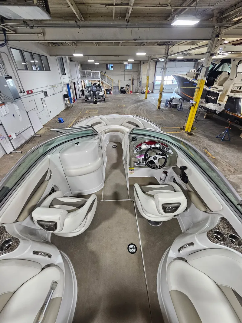 Slide: The Image of Interior view of a 2009 Crownline 240 LS boat in a workshop. - 9