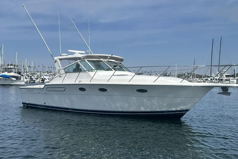 The Image of 1990 Tiara Yachts 3600 Open boat docked in a marina under clear skies. - 0