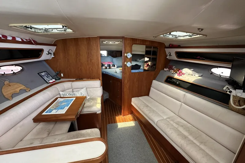 Slide: The Image of Luxurious interior of a 1990 Tiara Yachts 3600 Open, featuring cozy seating and elegant wood finishes. - 17