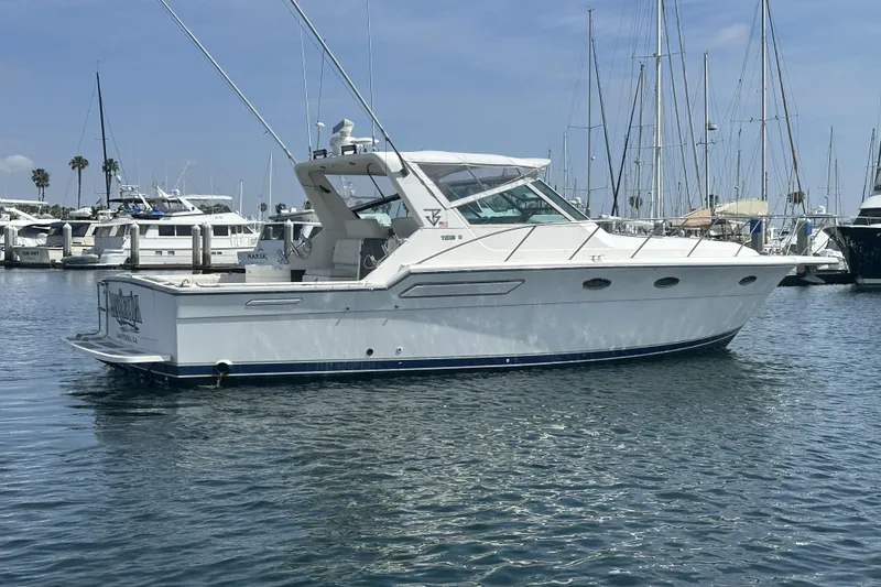 Slide: The Image of 1990 Tiara Yachts 3600 Open in marina, clear sky, calm water. - 2