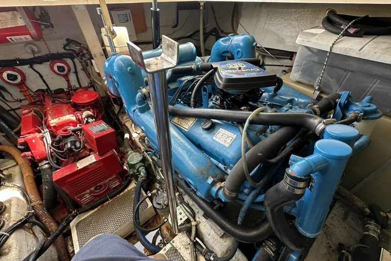 Slide: The Image of Engine room of a 1990 Tiara Yachts 3600 Open, featuring blue and red machinery. - 21