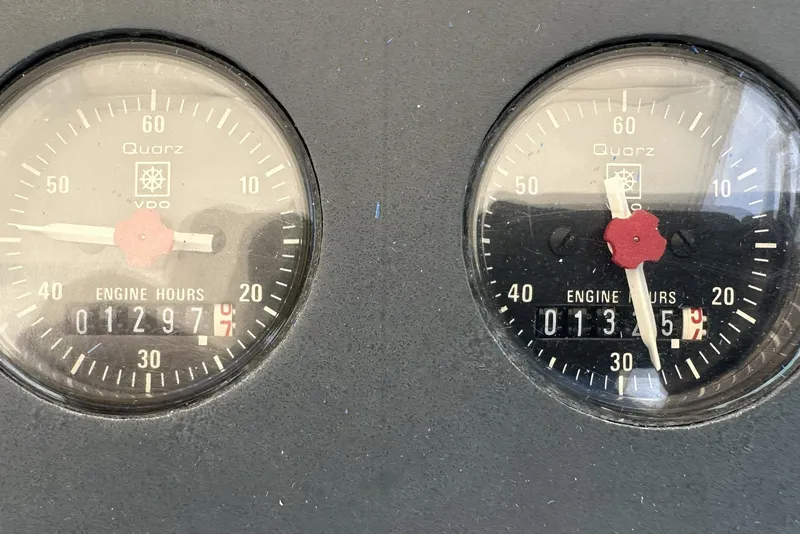 Slide: The Image of Close-up of Tiara Yachts 3600 Open 1990 engine hour meters displaying 1297 and 1355 hours. - 22