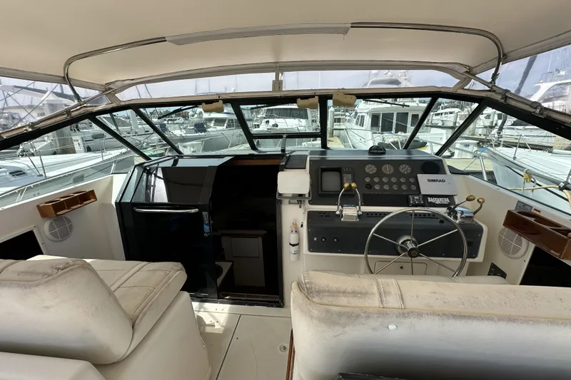 Slide: The Image of 1990 Tiara Yachts 3600 Open cockpit with steering wheel, controls, and navigation equipment. - 7