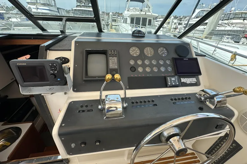 Slide: The Image of Cockpit of 1990 Tiara Yachts 3600 Open with navigation instruments and steering wheel. - 9