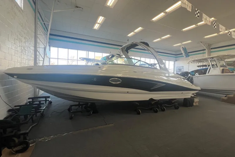 The Image of 2024 Crownline Eclipse E290 XS boat displayed indoors, showcasing sleek design and modern features. - 0