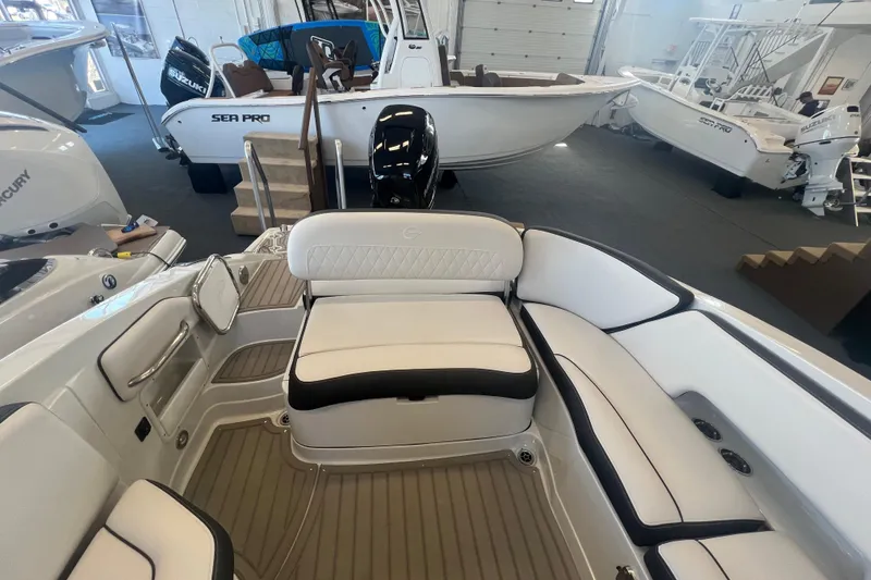 Slide: The Image of 2024 Crownline Eclipse E290 XS boat interior with white seating and modern design. - 11