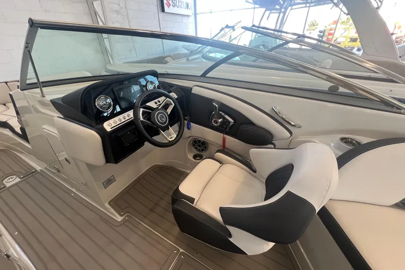 Slide: The Image of 2024 Crownline Eclipse E290 XS boat interior with modern dashboard and steering wheel. - 13