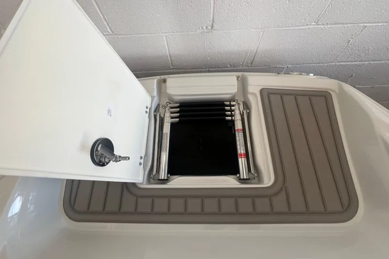 Slide: The Image of 2024 Crownline Eclipse E290 XS boat hatch with ladder, open on deck. - 15