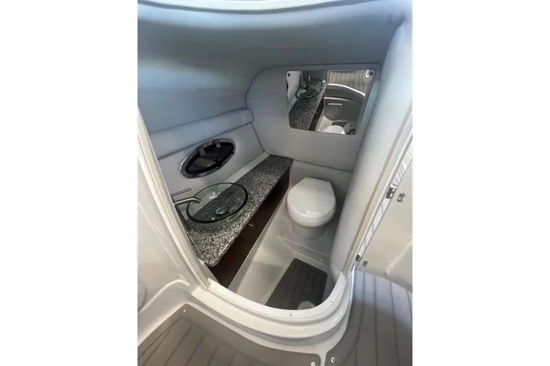 Slide: The Image of 2024 Crownline Eclipse E290 XS boat interior bathroom with modern fixtures and mirror. - 19