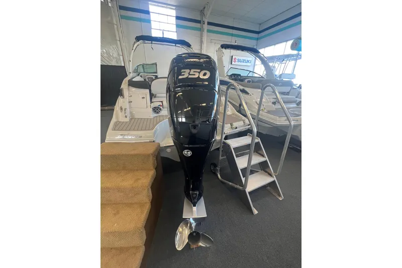 Slide: The Image of 2024 Crownline Eclipse E290 XS boat with powerful 350 outboard engine in showroom. - 8