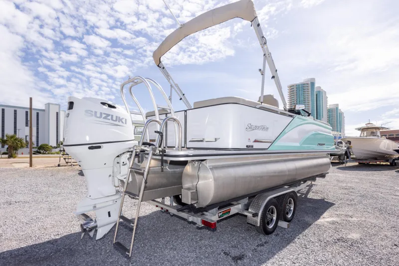 Slide: The Image of 2024 SilverWave 2210 CLS SW5 pontoon boat on trailer, displayed outdoors. - 11