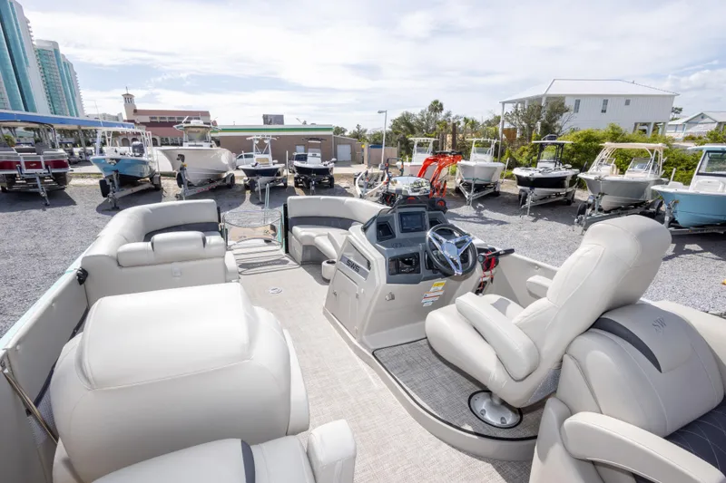 Slide: The Image of 2024 SilverWave 2210 CLS SW5 pontoon boat with luxurious seating at a marina. - 14