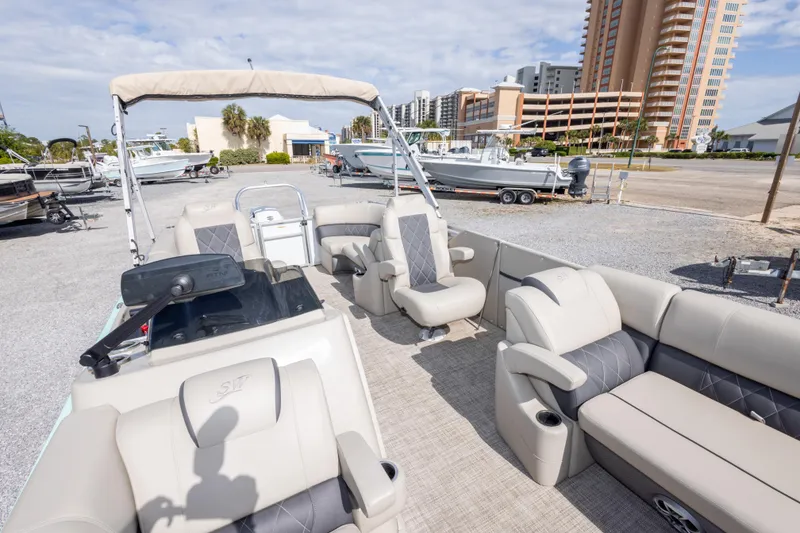 Slide: The Image of 2024 SilverWave 2210 CLS SW5 pontoon boat with luxurious seating and modern design in a marina. - 23