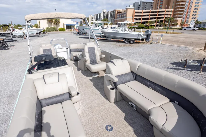 Slide: The Image of 2024 SilverWave 2210 CLS SW5 pontoon boat with spacious seating and modern design in a marina. - 25