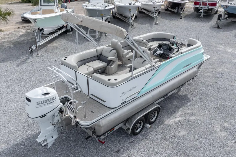 Slide: The Image of 2024 SilverWave 2210 CLS SW5 pontoon boat on trailer, featuring Suzuki outboard motor. - 32