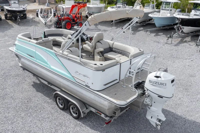 Slide: The Image of 2024 SilverWave 2210 CLS SW5 pontoon boat with outboard motor, parked on gravel. - 34