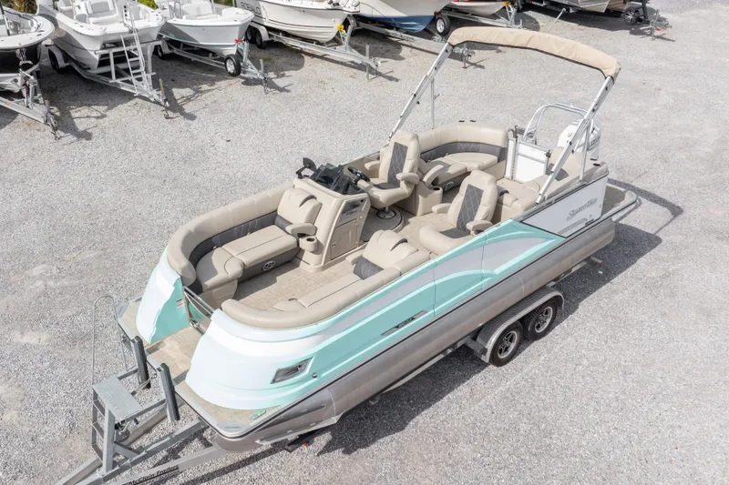 Slide: The Image of 2024 SilverWave 2210 CLS SW5 pontoon boat with Suzuki outboard motor, parked on gravel. - 36